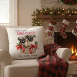 Decorative pillow with pug illustration on a chair in a festive living room.