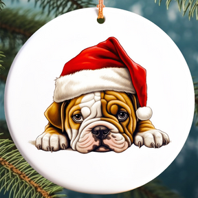 A ceramic Christmas ornament featuring an English Bulldog puppy wearing a Santa hat, designed for hanging on a Christmas tree.