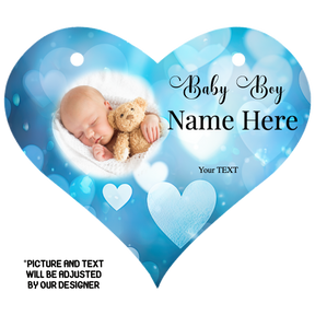 A heart-shaped, personalised hanging sign with a baby boy illustration, blue background, white hearts, and customizable text areas for a name and message.
