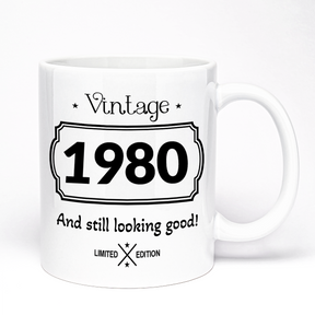 A white ceramic mug with vintage design featuring the text 'Vintage 1980 And still looking good! Limited Edition'.