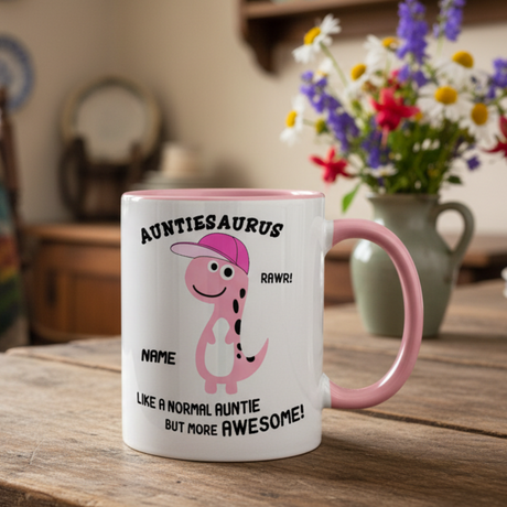 Mug with 'Auntiesaurus' design on a wooden table with flowers in the background