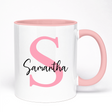 White mug with pink interior and handle, featuring a pink letter 'S' and the name 'Samantha'.