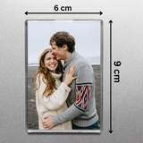 Fridge magnet with a couple embracing, showing dimensions on a gray background